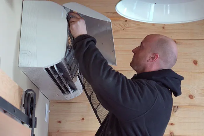 A.J. LeBlanc Heating technician installing a mini split heat pump