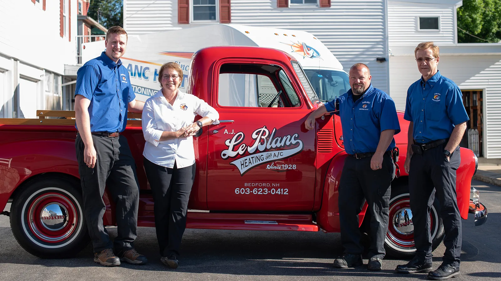 The A.J. LeBlanc Heating team beside the company's restored 1928 pickup truck in Bedford, NH