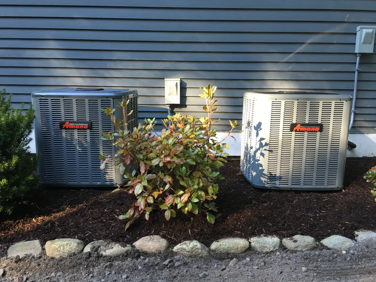 Two Amana central air conditioner condensers at a New Hampshire home installed by A.J. LeBlanc Heating