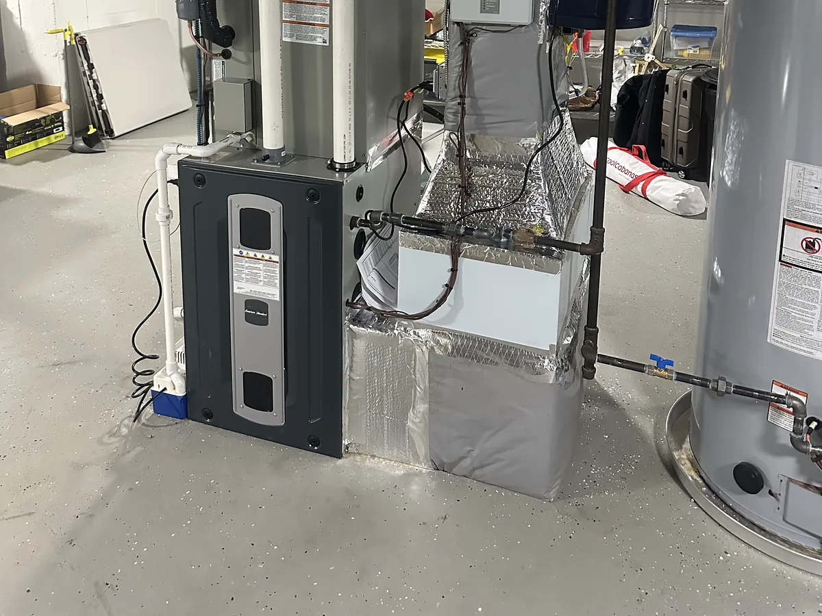 American Standard gas furnace installation with foil-wrapped supply plenum and water heater in a Southern NH basement mechanical room by A.J. LeBlanc Heating