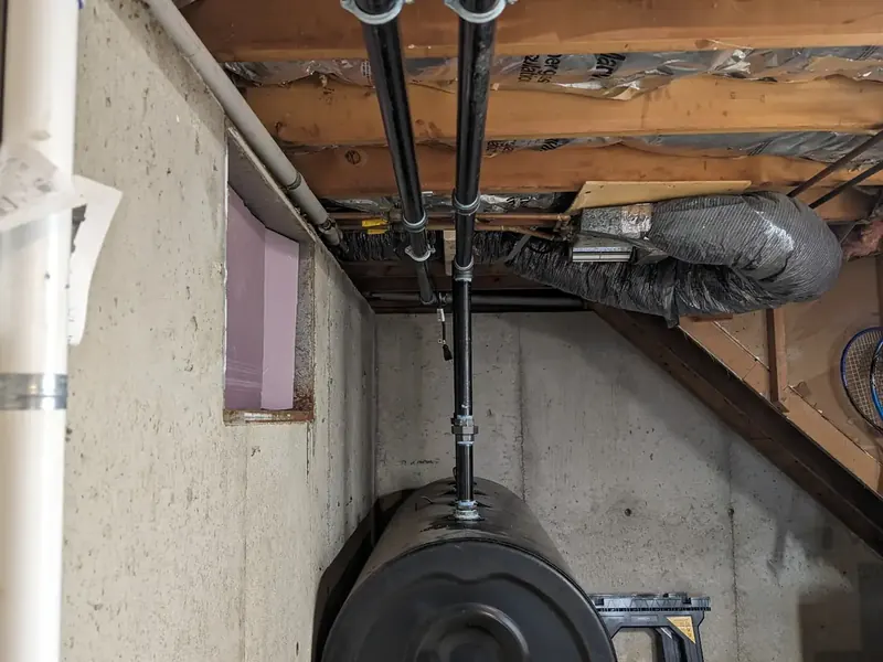 Standard 275-gallon black oil tank installation by A.J. LeBlanc Heating in a Southern NH basement