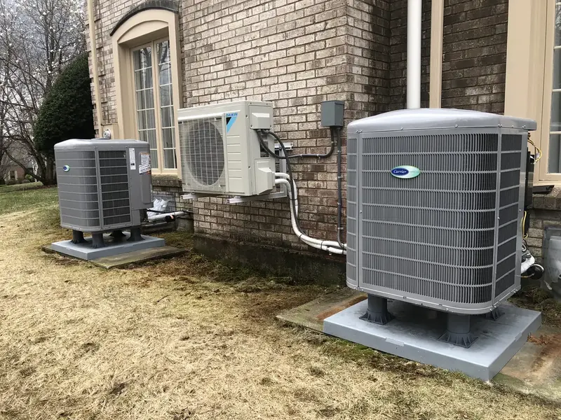 Carrier central air conditioner paired with a Daikin mini split outdoor unit at a brick Southern NH home installed by A.J. LeBlanc Heating