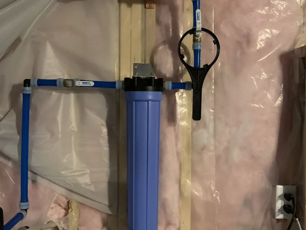 Whole-house cartridge filter housing with connected water piping