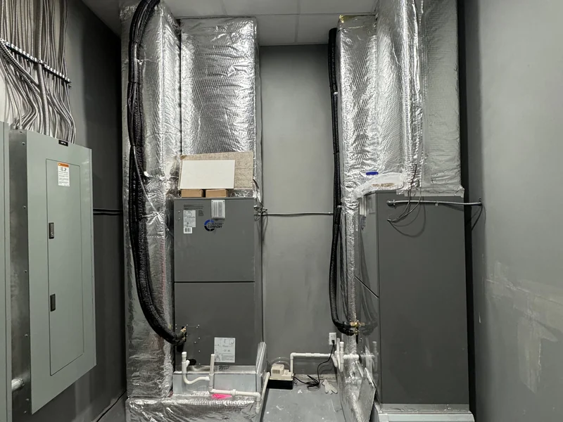 Ducted heat-pump equipment and insulated connections installed by A.J. LeBlanc Heating in Concord, New Hampshire