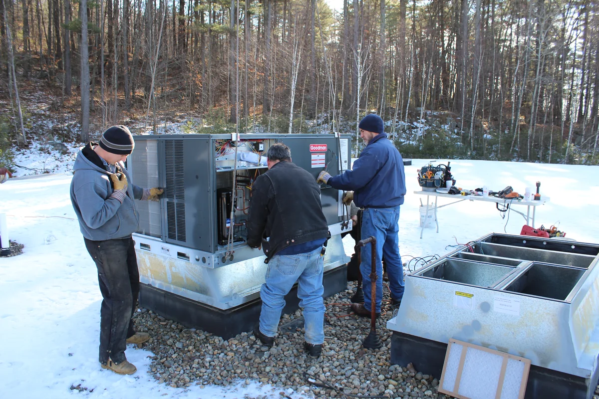 A.J. LeBlanc Heating technicians working on rooftop packaged HVAC equipment