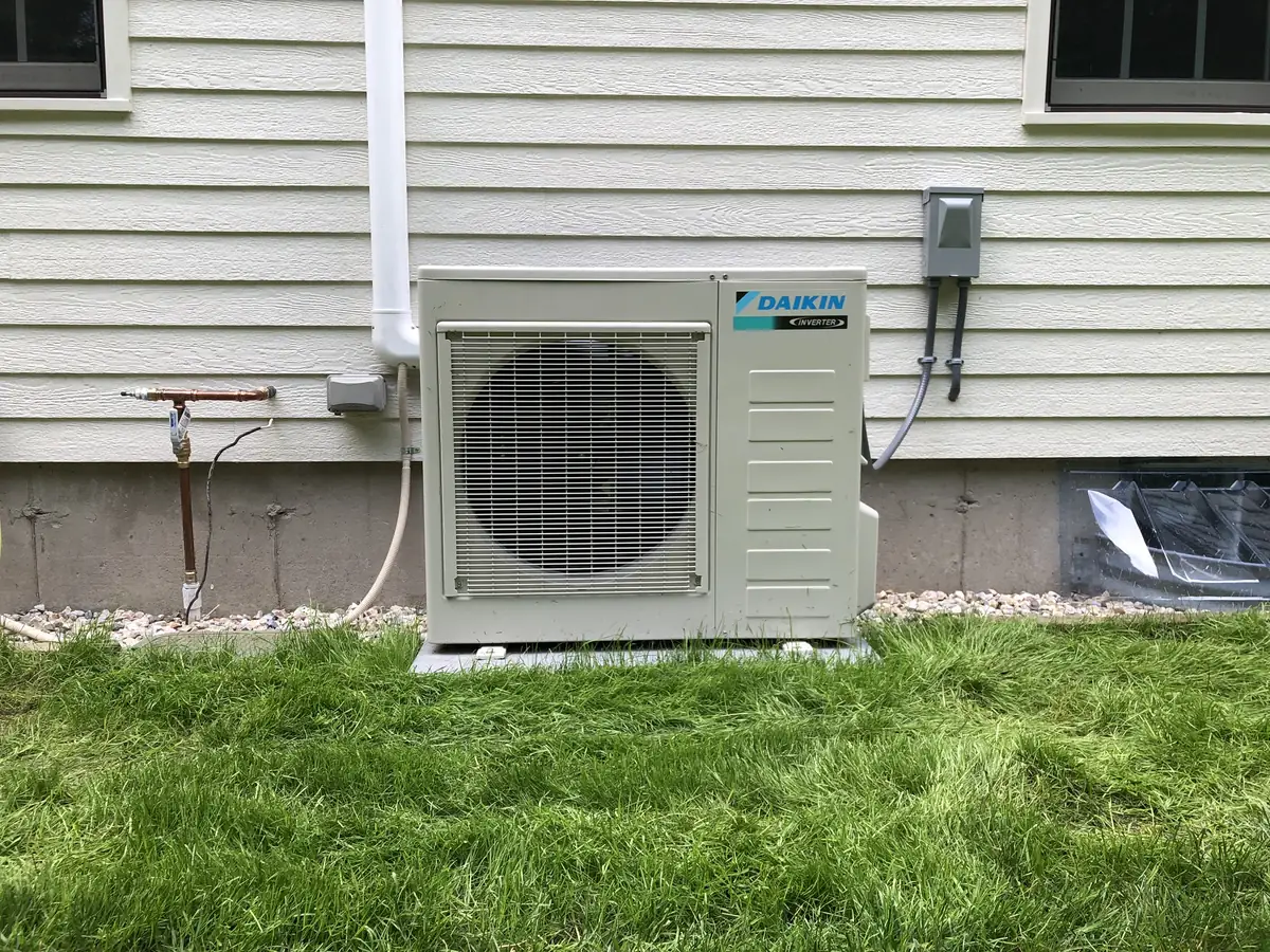 Daikin heat pump outdoor condenser at a New Hampshire home installed by A.J. LeBlanc Heating