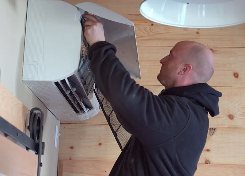 Air conditioning technician changing a filter