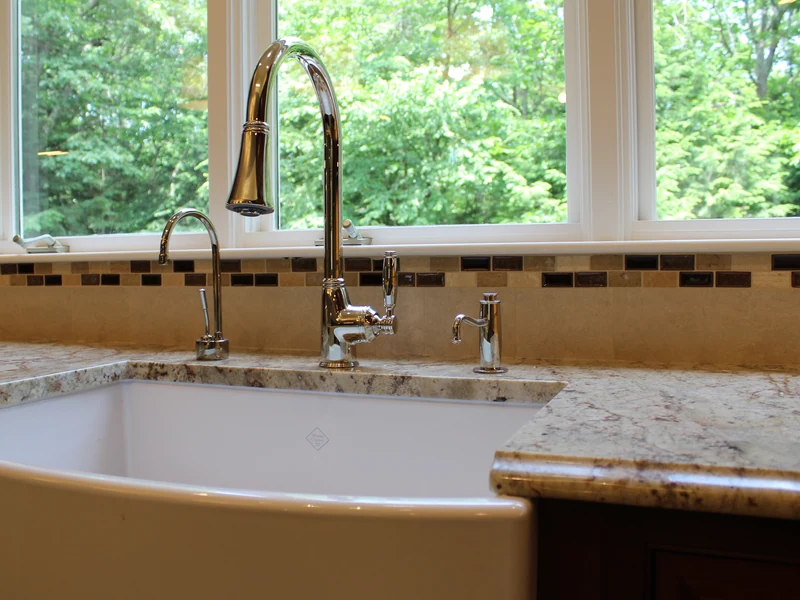 White farmhouse apron-front kitchen sink installed by A.J. LeBlanc Heating in a Southern NH home