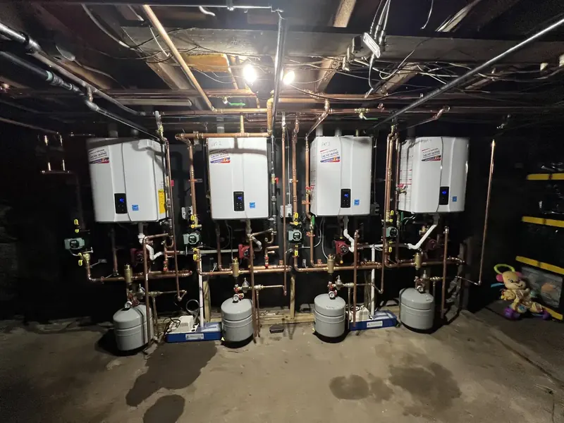 Four-unit Navien tankless cascade installed by A.J. LeBlanc Heating in a Southern NH apartment building