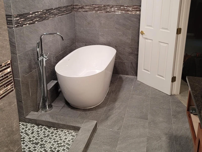 Modern freestanding bathtub installed by A.J. LeBlanc Heating in a Southern NH home