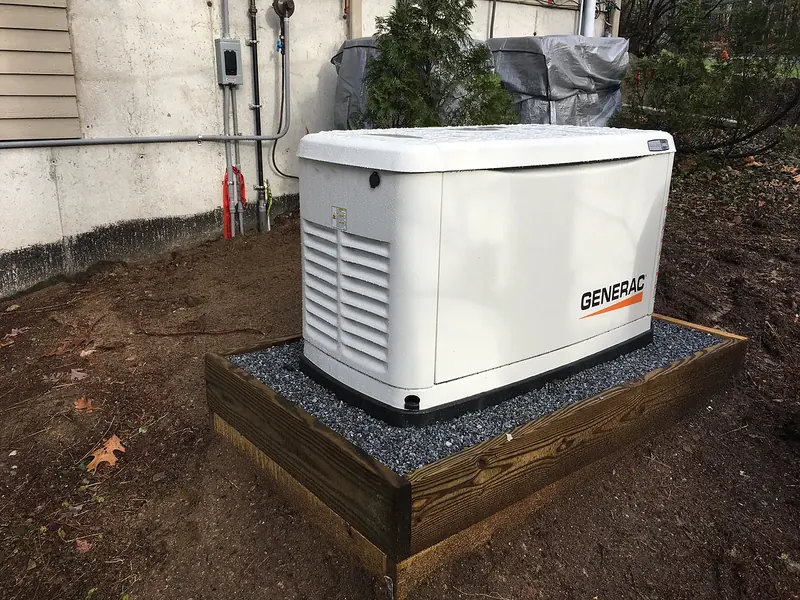Generac whole-home standby generator on a custom timber-framed gravel pad installed by A.J. LeBlanc Heating in Southern NH