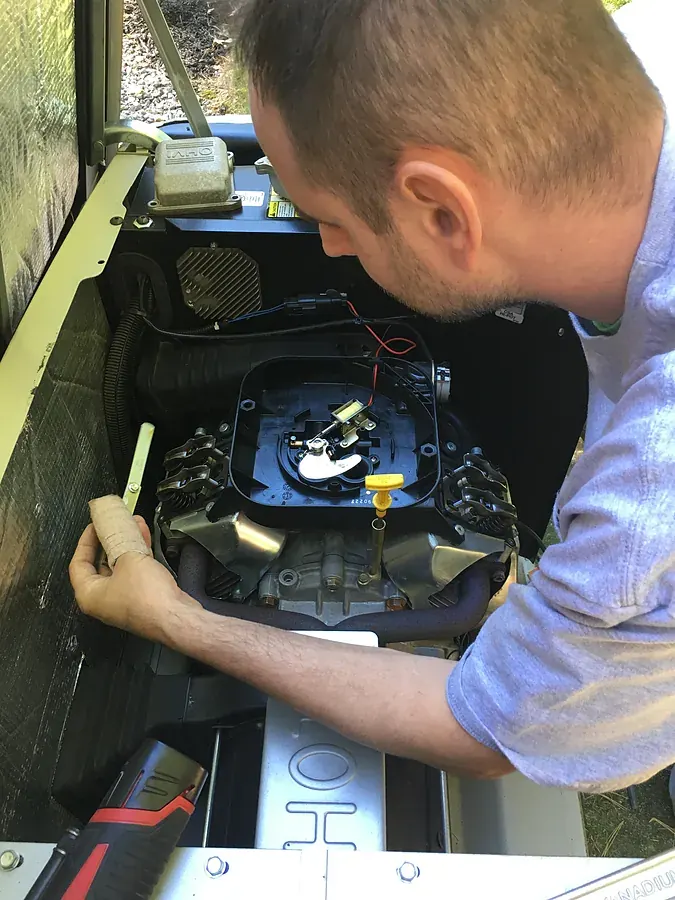 A.J. LeBlanc Heating technician performing a valve adjustment on a residential standby generator in Southern NH