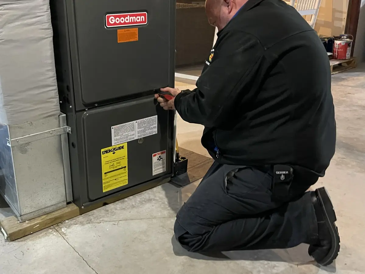 A.J. LeBlanc Heating technician performing an annual tune-up on a Goodman gas furnace in Southern NH