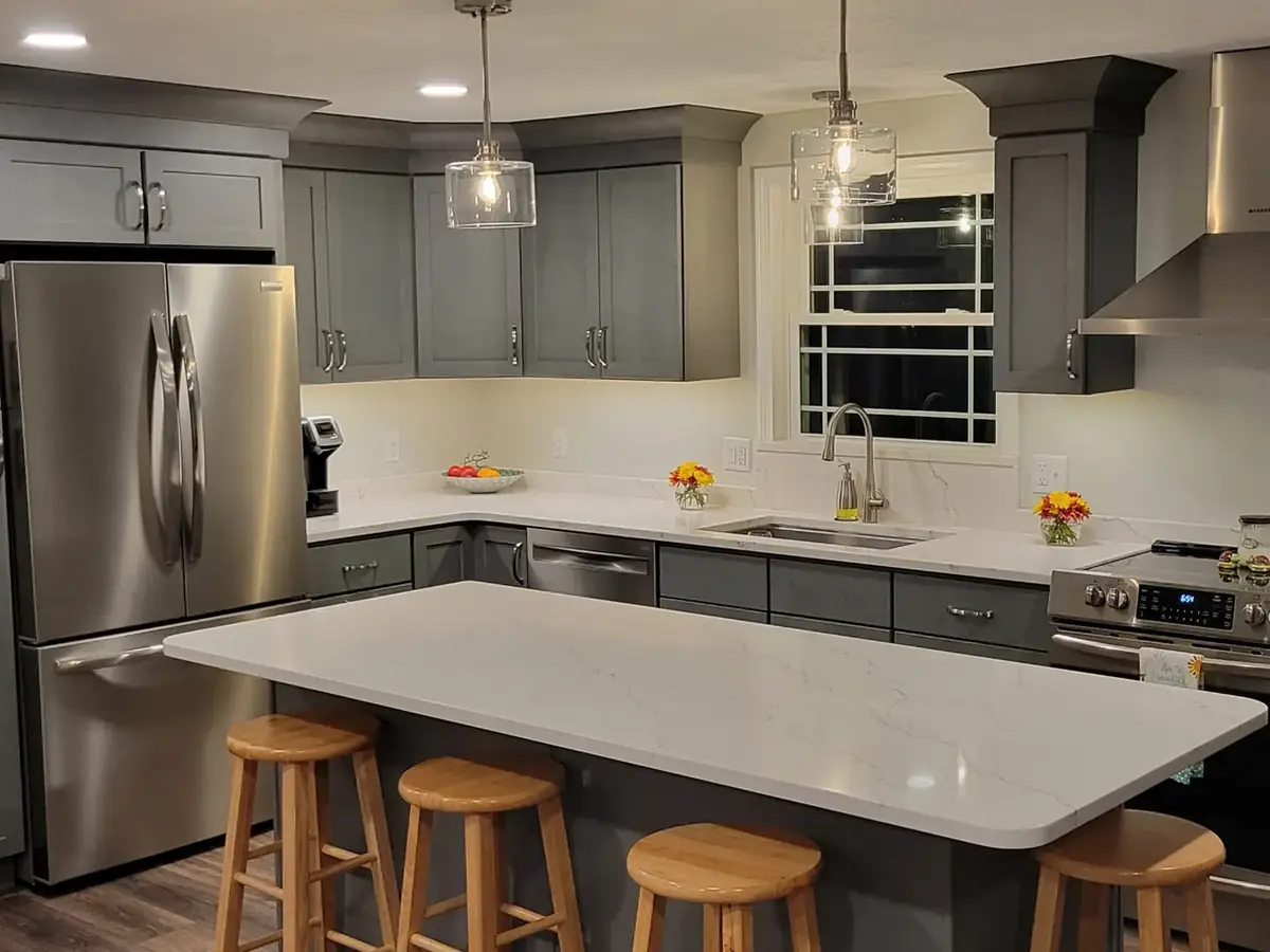 Kitchen remodel with gray cabinets and quartz counters by A.J. LeBlanc Heating in a Southern NH home