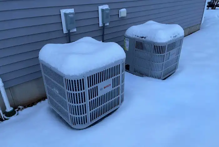 Heat pump covered in snow