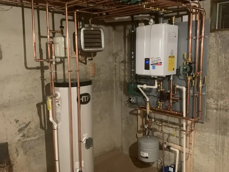 HTP SuperStor indirect water heater paired with a Navien wall-hung condensing boiler installed by A.J. LeBlanc Heating in Southern NH