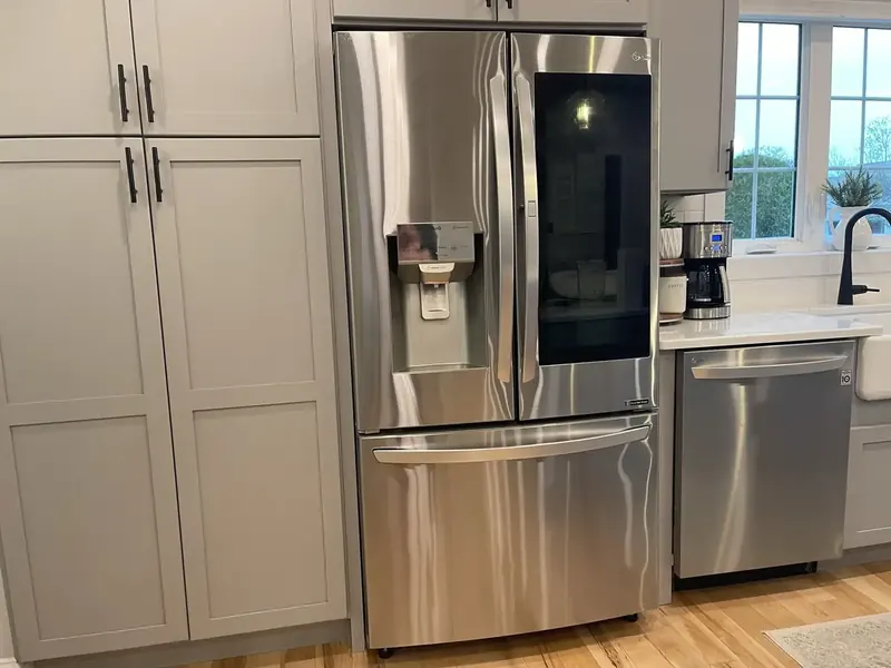 LG French-door stainless steel refrigerator with ice and water dispenser hooked up by A.J. LeBlanc Heating in a Southern NH kitchen