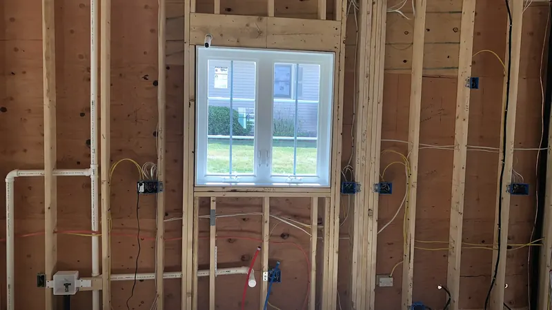 New construction wall framing with PEX hot and cold water lines and PVC drain rough-in by A.J. LeBlanc Heating in Southern NH