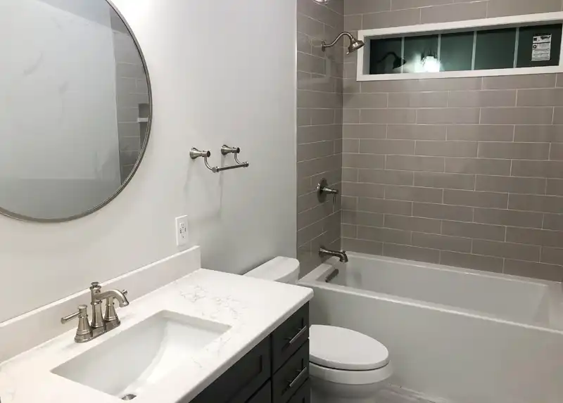 Kohler toilet with subway tile shower
