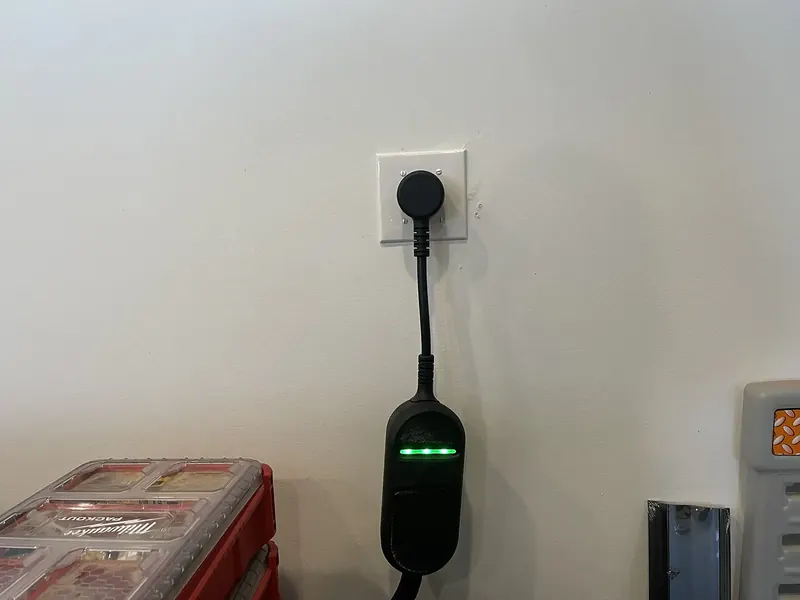 Portable EV charger plugged into a NEMA 14-50 outlet installed by A.J. LeBlanc Heating