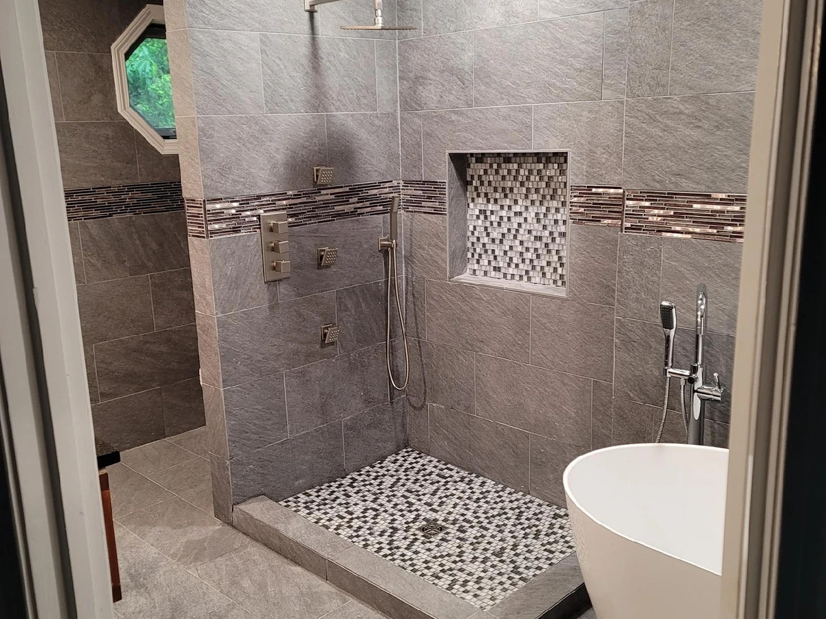Rain head, body sprays, handheld wand, and shower plumbing installed by A.J. LeBlanc Heating in a Southern NH home