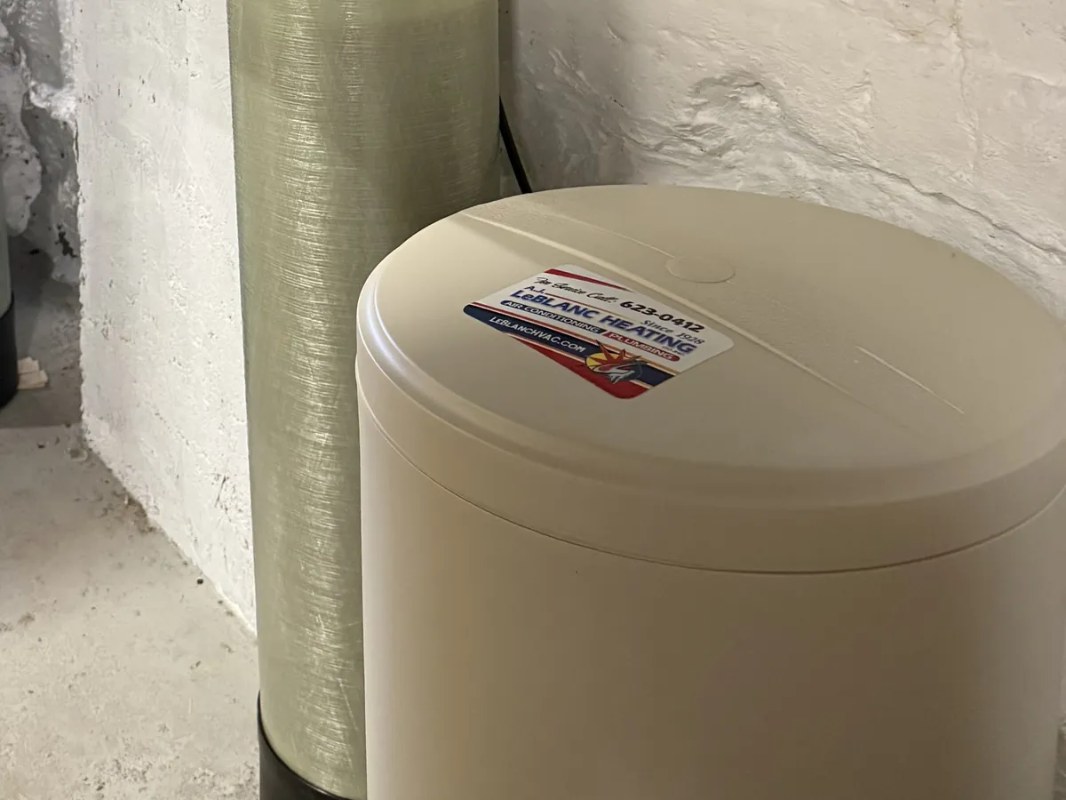 Water softener resin tank and A.J. LeBlanc Heating-branded brine tank installed in a Southern NH basement